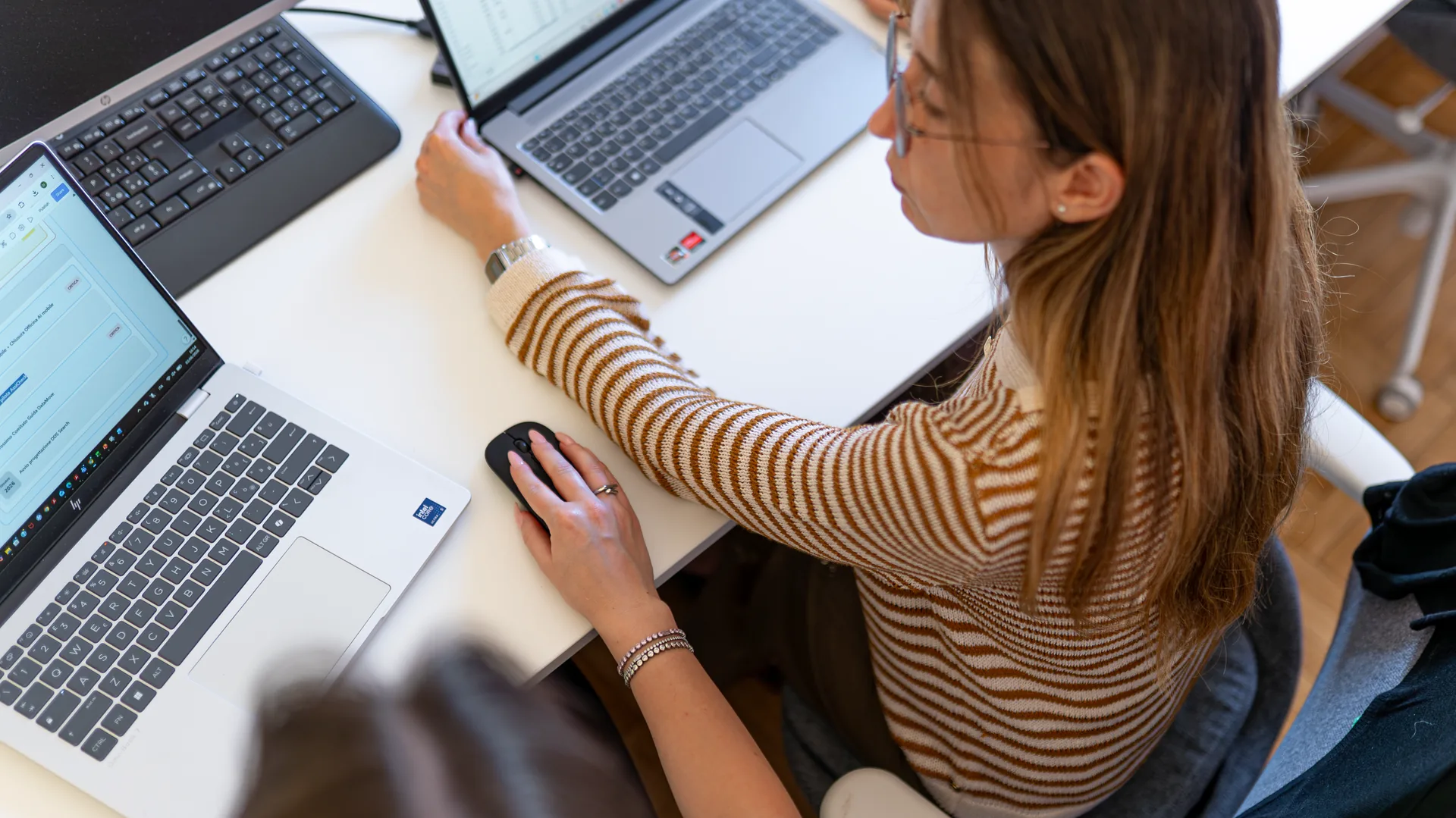A FIT Academy professional working with data across multiple computers